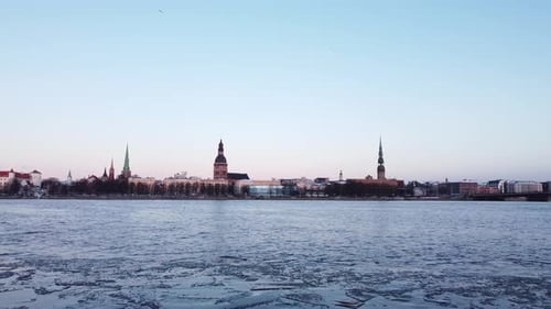 Iced frozen Daugava river in Riga, Latvia, static establisher view, dusk