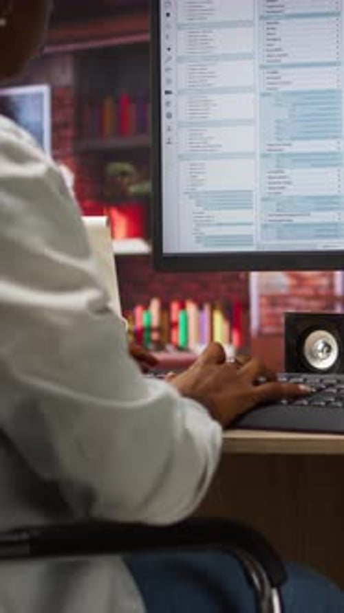 Vertical Video System Administrator Types Code Into PC Developing Software