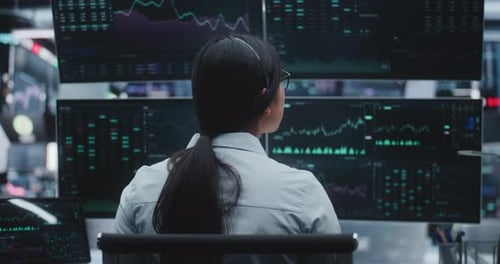 Woman With Long Tail Sits Sophisticated Workstation in Huge Innovative Digital Center