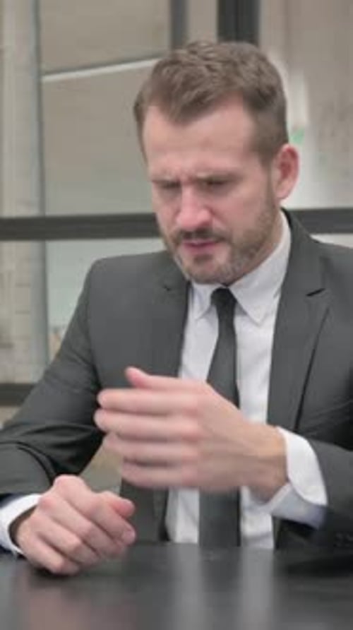 Stressed Man in Suit at Desk