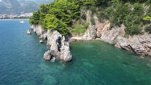 Drone Flight Over a Picturesque Rocky Mediterranean Coastline with Clear Turquoise Water on a Sunny
