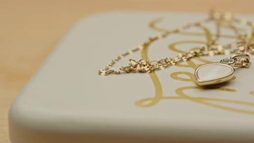 Elegant Gold Necklace Pendant on Jewelry Box