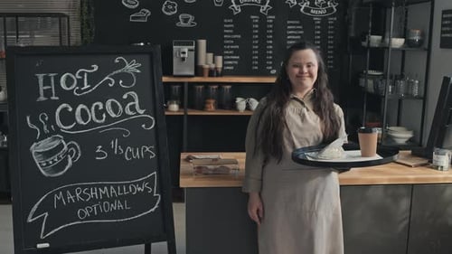 Smiling Woman Serving Drink and Pastry in Cafe