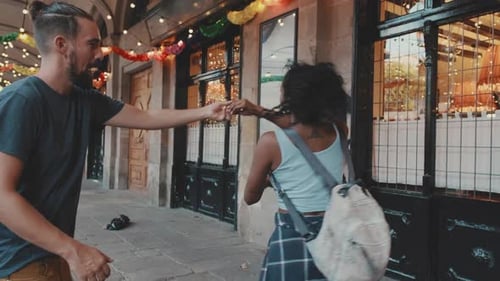 Feliz pareja interracial bailando al aire libre