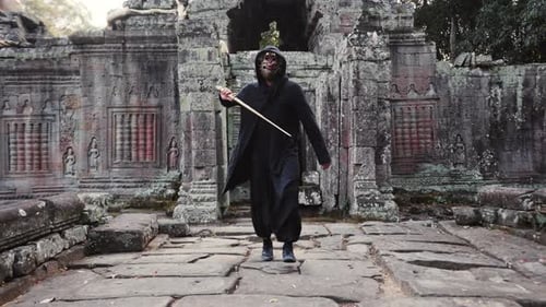 Masked Figure Practices Swordplay in Ancient Temple Ruins