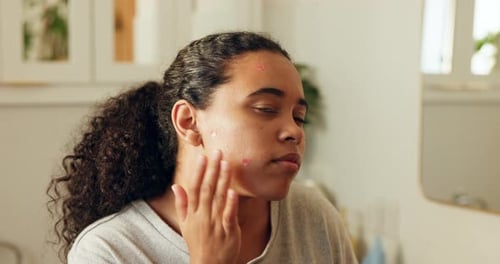 Woman, skincare and pimple patch in bathroom with inspection, blemish control or wellness benefits