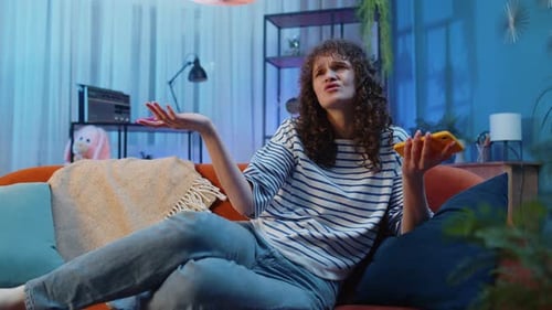 Woman Relaxing on Couch Uses Mobile Phone