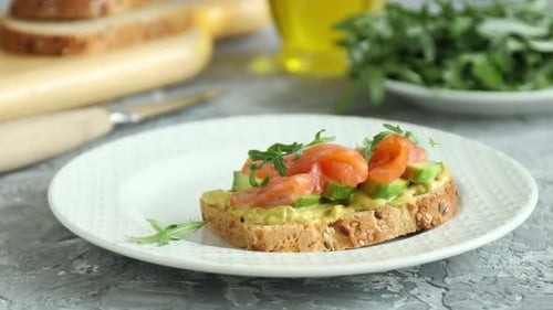 Toast with Avocado and Salmon on a Plate