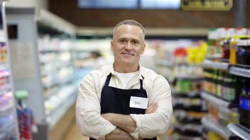 Portrait of a Middleaged Shop Worker in an Apron