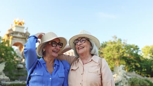 Happy senior women tourists laughing together in barcelona
