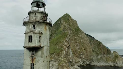Weathered Lighthouse Near Rocky Island Cliffs