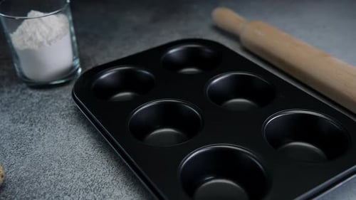 Muffin Tin and Baking Ingredients on Countertop