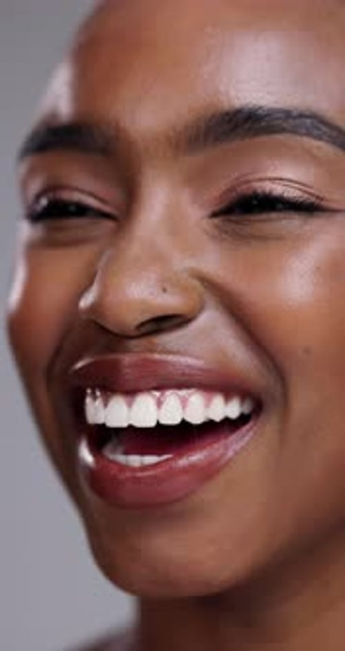Happy black woman, teeth and laughing for dental hygiene, skincare or cosmetics on a gray studio