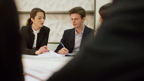 Adults Meeting at Conference Table in Workplace