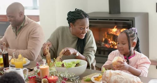 Family Meal at a Dinner Table by Fireplace