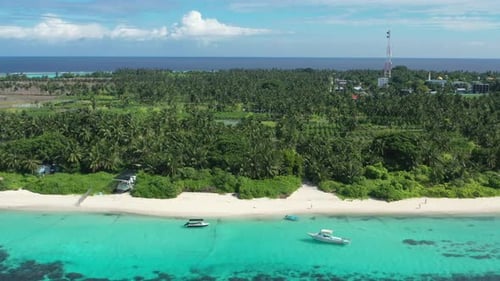 Aerial view of turquoise waters, white sand beaches, lush greenery, Maldives.
