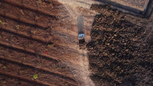 Aerial view of heavy earthmovers in construction site.