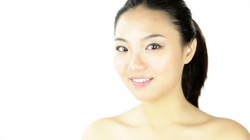 Attractive woman from east asia in her 20s isolated in studio