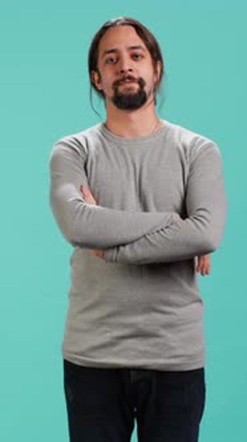 Man Posing with Arms Crossed in Studio Setting