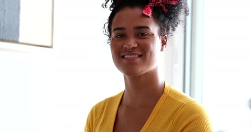 Happy excited young mixed race woman celebrating success with fist