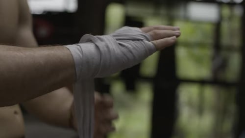 Man Wrapping Hands Getting Ready to Box