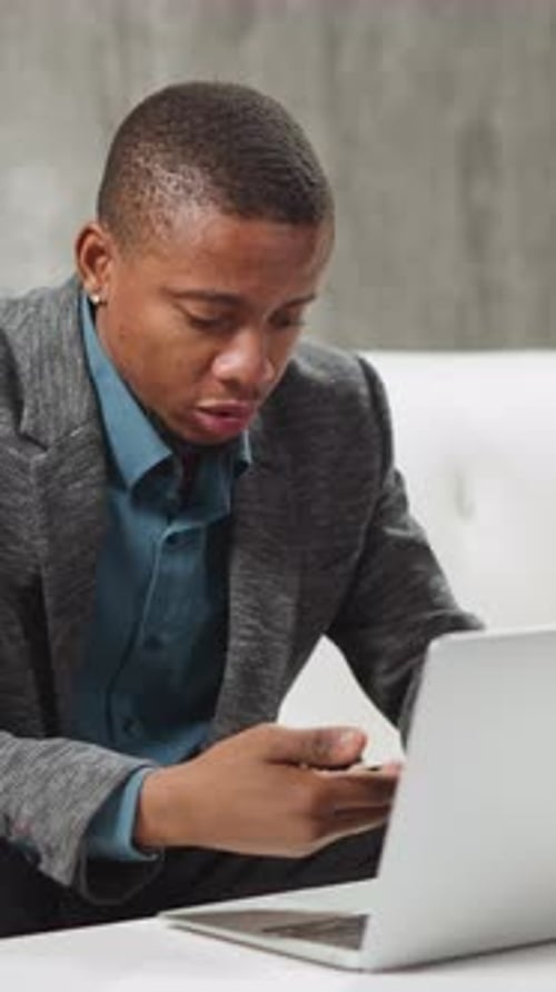 Young Adult Speaking in Front of Laptop