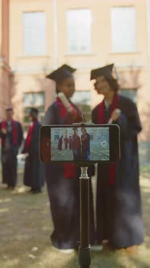 Students Filming Video during Graduation Ceremony Using Smartphone in Tripod