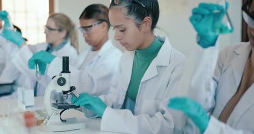 University, science and students in laboratory with microscope for learning, lesson and practical