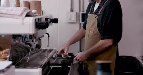 Man Making Espresso at Professional Coffee Machine