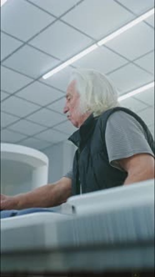 Man Placing Belongings in Airport Security Bin