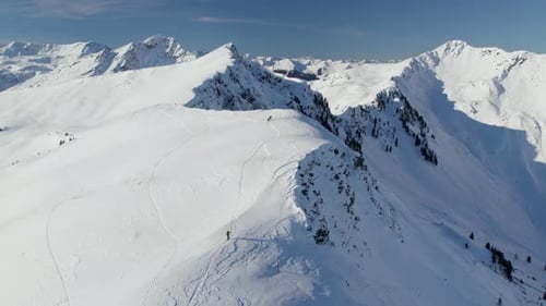 Skier Over Snowscape Mountain Hikes Near Saalbach-Hinterglemm, Austria. Aerial Drone Shot