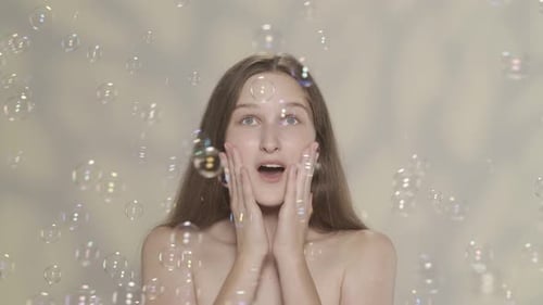 Enchanting Woman Surrounded by Floating Soap Bubbles