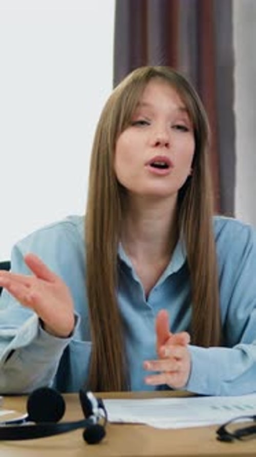 Young Woman Communicates During Business Meeting at Desk