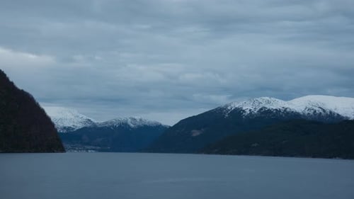 Scenic shot of a fjord in Norway on a cold winter day with clouds covering the sky