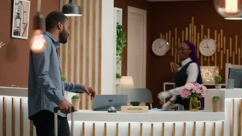 Hotel Guest at Reception Desk Rings Bell