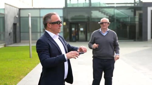 Men Use Augmented Reality Glasses Outside Building