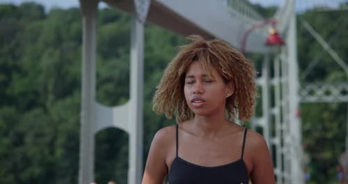 Young African American Woman Runner Jogging on City Bridge Outdoors
