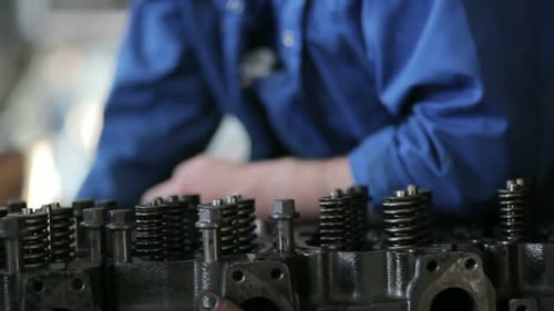 Truck engine repair close up in a service centre with skilled technician