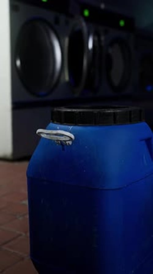 A Blue Barrel Sitting in Front of a Washer