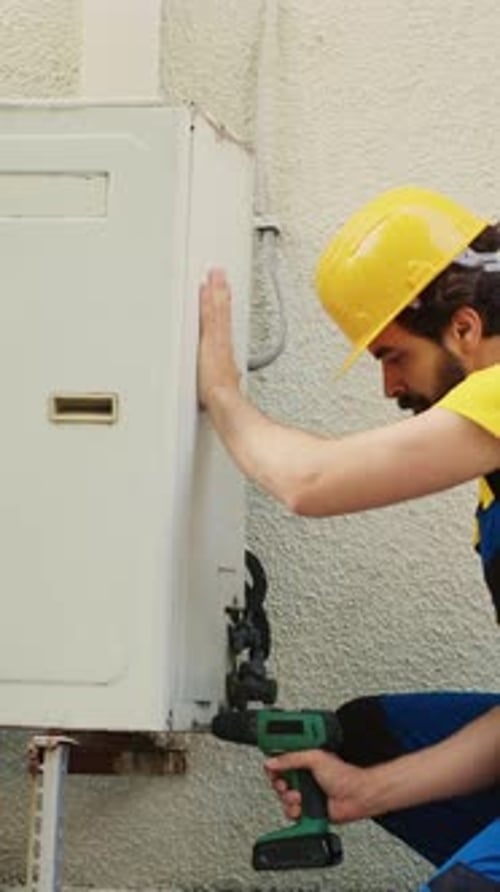 Vertical Video Wireman Dissasembling Air Conditioner