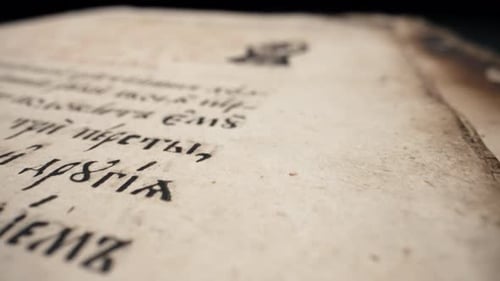 Weathered Page of Ancient Manuscript with Intricate Illustrations