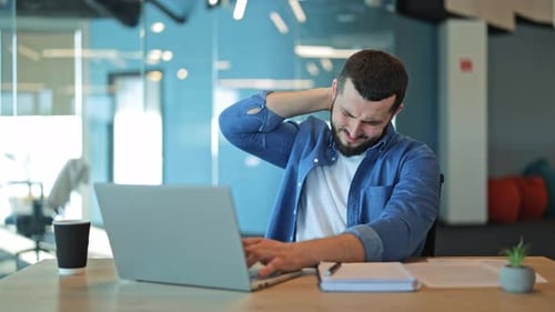 Office Worker With Neck Pain From Laptop Use