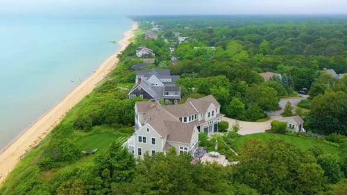 Cape Cod Oceanfront Community with Sandy Shoreline and Cloudy Sky