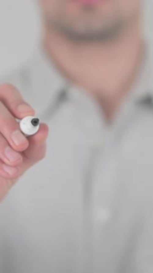 Man Writing Setup on Clear Surface Close Up