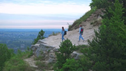 Couple Hiking Mountain Trail Overlooking City