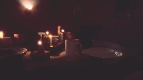 Flickering Candles on a Dinner Table for Celebrations