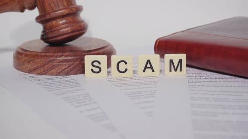 Gavel on Legal Document Beside Scam Block Letter