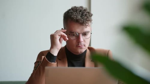 IT Specialist or Creative Designer is Working in Office Thinking and Looking at Window Portrait