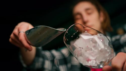 Filling Wine Glass with Ice at Night