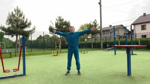 A male athlete warms up at the outdoor gym
